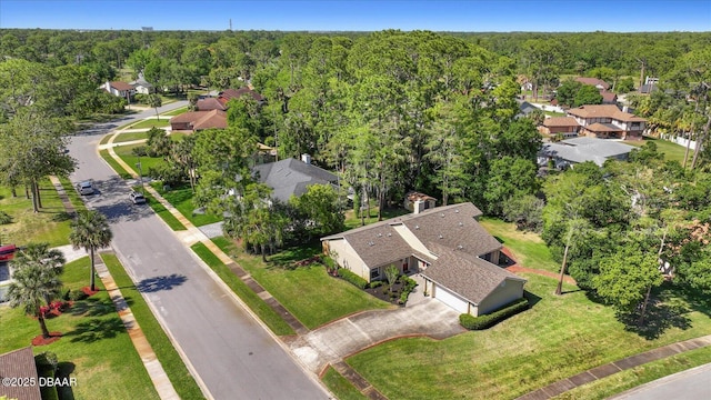 drone / aerial view featuring a view of trees and a residential view