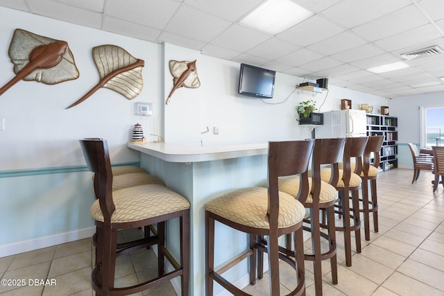 89 S Atlantic Ave Unit 1004, Ormond Beach, FL 32176 - bar with a paneled ceiling and tile patterned flooring