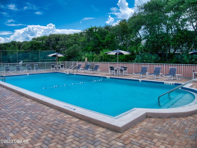 view of swimming pool featuring a patio area