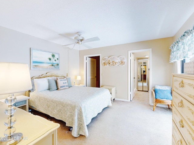 bedroom featuring ceiling fan and light carpet