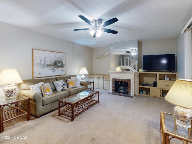 carpeted living room with a brick fireplace, ceiling fan, and a textured ceiling