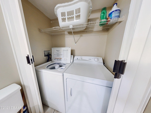 washroom with independent washer and dryer