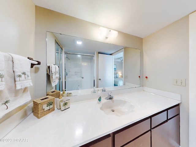 bathroom with walk in shower and vanity