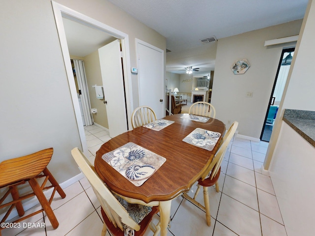 tiled dining room featuring ceiling fan