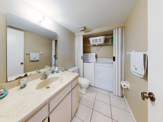 bathroom with vanity, separate washer and dryer, tile patterned flooring, and toilet