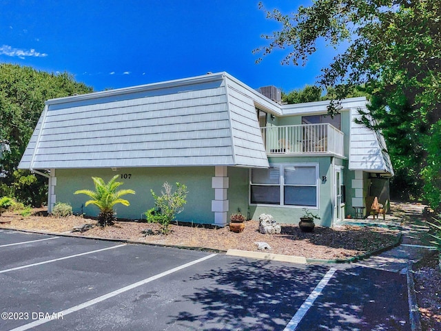 view of side of property with a balcony