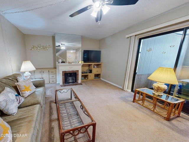 carpeted living room with a brick fireplace, ceiling fan, and a textured ceiling