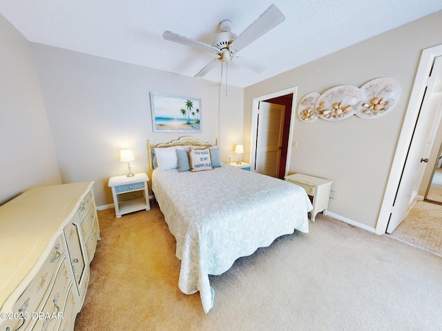 bedroom with ceiling fan and light colored carpet