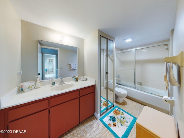 full bathroom featuring toilet, combined bath / shower with glass door, vanity, and tile patterned flooring