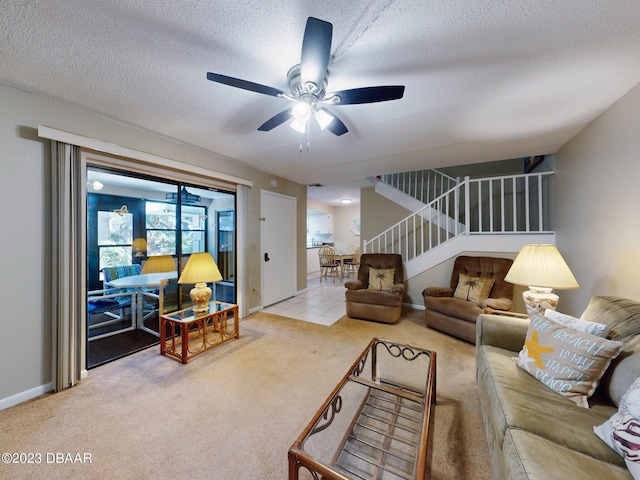 living room with carpet floors, a textured ceiling, and ceiling fan