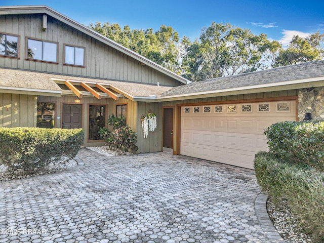 view of front of house with a garage and decorative driveway