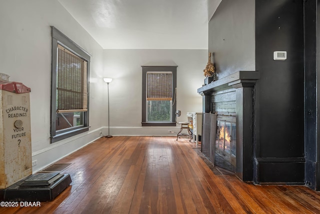 unfurnished living room with dark wood-type flooring