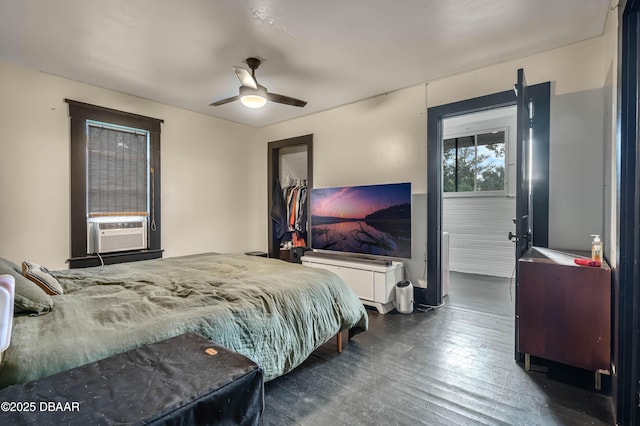 bedroom featuring ceiling fan, dark hardwood / wood-style flooring, and cooling unit