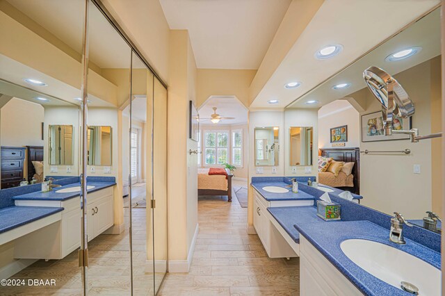 bathroom featuring wood-type flooring, ceiling fan, and vanity