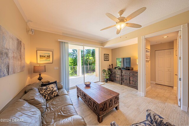 living room featuring ornamental molding, ceiling fan, and light hardwood / wood-style flooring