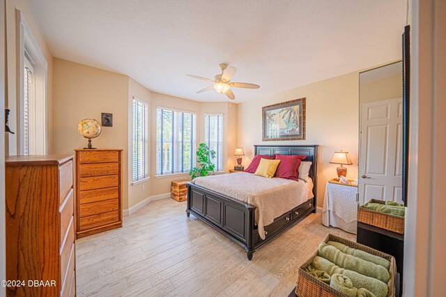 bedroom featuring light hardwood / wood-style flooring and ceiling fan