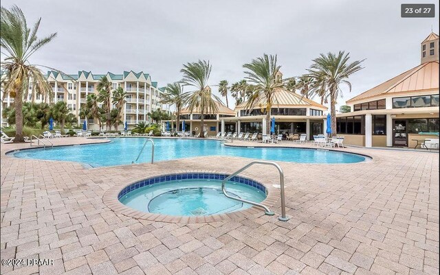 view of pool featuring a gazebo, a patio, and a hot tub