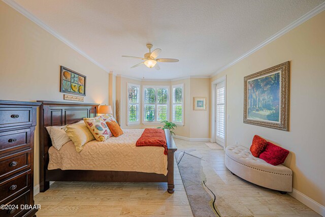 bedroom featuring light wood-type flooring, ceiling fan, and crown molding