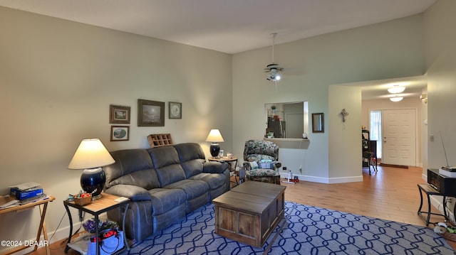 living room featuring hardwood / wood-style floors and ceiling fan