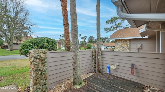 wooden terrace featuring a yard