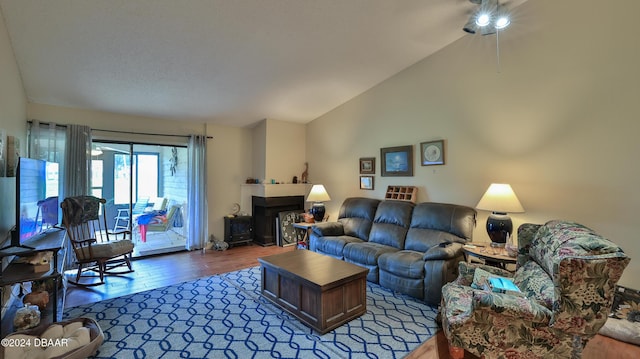 living room with hardwood / wood-style floors and vaulted ceiling