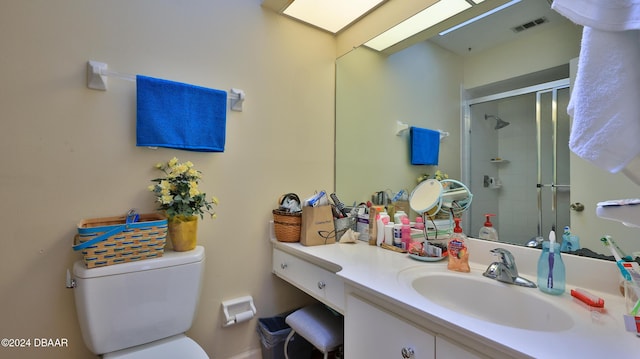 bathroom featuring vanity, toilet, and walk in shower