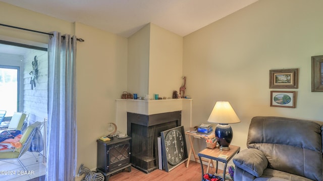 interior space with a multi sided fireplace and light hardwood / wood-style flooring