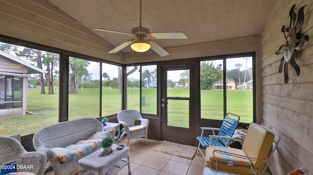 sunroom with ceiling fan and lofted ceiling