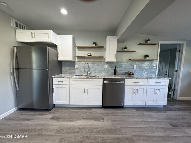 kitchen featuring stainless steel appliances, white cabinetry, light hardwood / wood-style floors, and sink