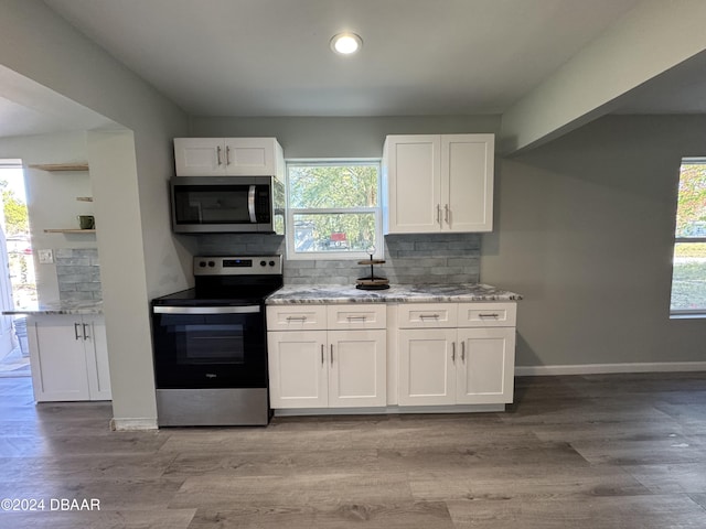 kitchen with a healthy amount of sunlight, white cabinetry, and stainless steel appliances