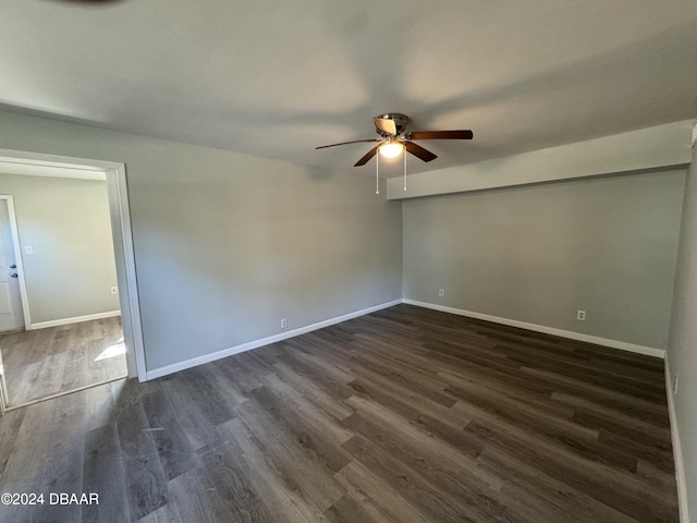 empty room with ceiling fan and dark wood-type flooring