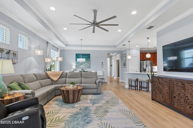 831 Coral Reef Way, Daytona Beach, FL 32124 - living room featuring light wood finished floors, visible vents, crown molding, and ceiling fan