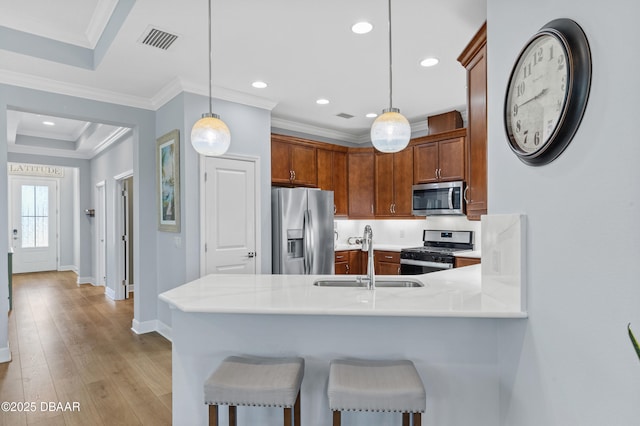 831 Coral Reef Way, Daytona Beach, FL 32124 - kitchen with visible vents, a peninsula, a sink, stainless steel appliances, and light countertops