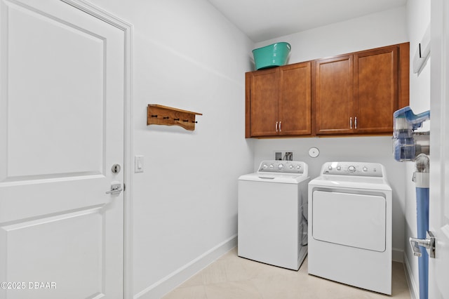 831 Coral Reef Way, Daytona Beach, FL 32124 - washroom with baseboards, cabinet space, and washer and clothes dryer