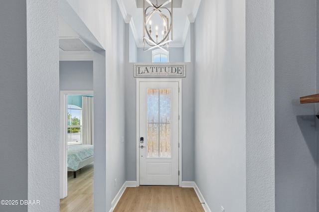 831 Coral Reef Way, Daytona Beach, FL 32124 - entryway with an inviting chandelier, wood finished floors, baseboards, and ornamental molding