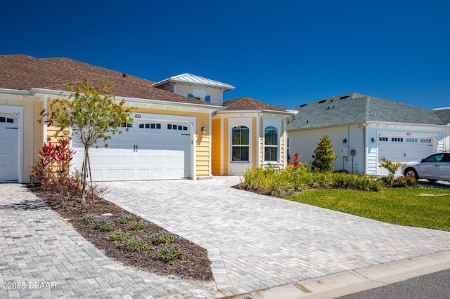 831 Coral Reef Way, Daytona Beach, FL 32124 - view of front of house featuring decorative driveway and a garage