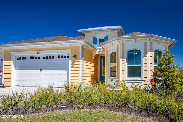 831 Coral Reef Way, Daytona Beach, FL 32124 - view of front of property featuring concrete driveway, a garage, and a shingled roof