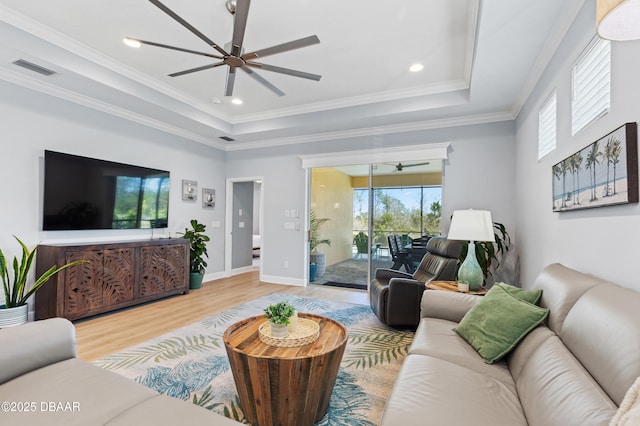 831 Coral Reef Way, Daytona Beach, FL 32124 - living room with a tray ceiling, wood finished floors, a ceiling fan, and ornamental molding