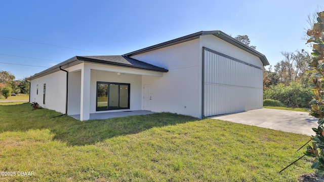 back of property with a patio and a lawn