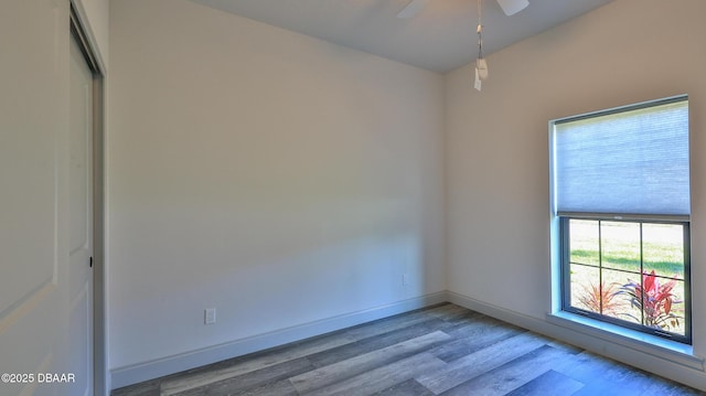 unfurnished room featuring light wood-type flooring and ceiling fan