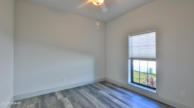 empty room with ceiling fan and wood-type flooring