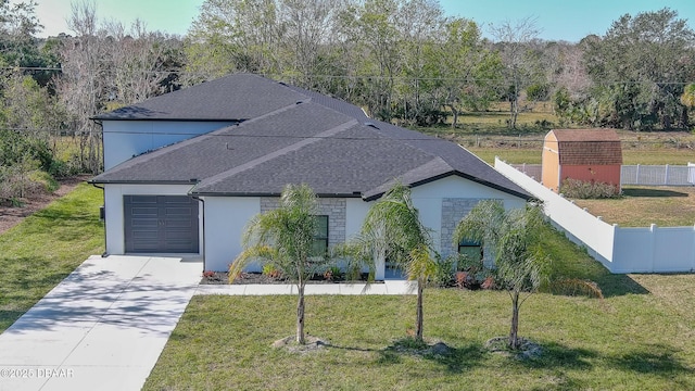 view of front of home featuring a garage and a front lawn