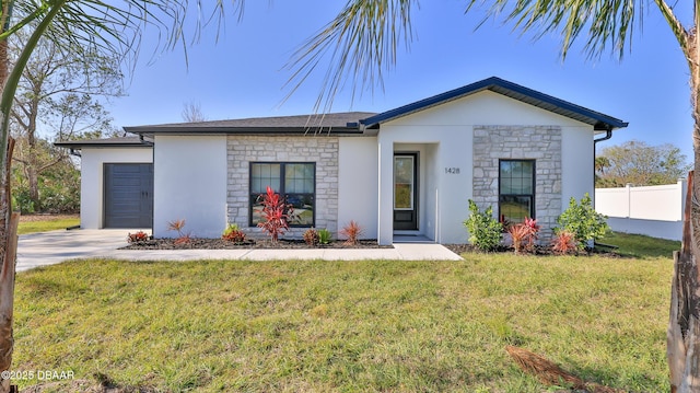 single story home with a front yard and a garage