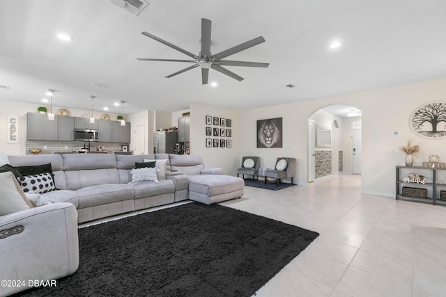 living room with ceiling fan and light tile patterned flooring