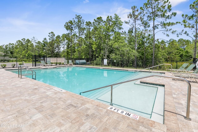 view of swimming pool with a patio