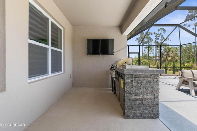 view of patio featuring an outdoor kitchen and a lanai