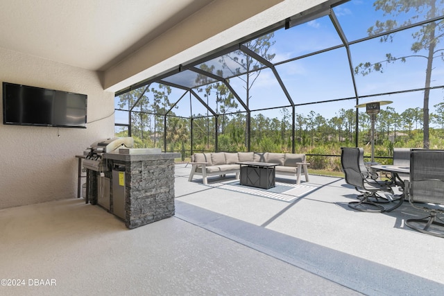 view of patio with outdoor lounge area, area for grilling, a lanai, and exterior kitchen