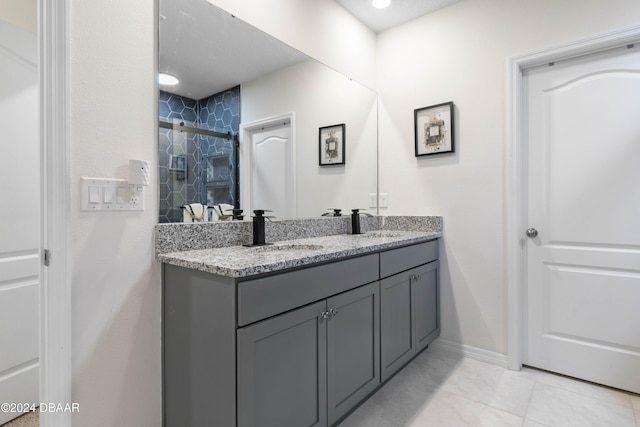 bathroom with tile patterned floors, vanity, and an enclosed shower