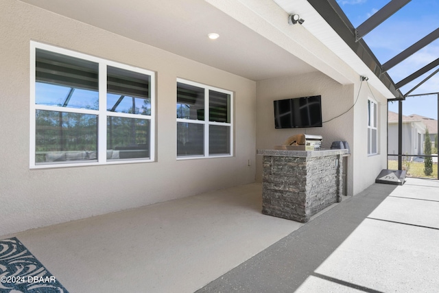 view of patio / terrace featuring area for grilling and a lanai