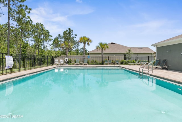 view of swimming pool with a patio area